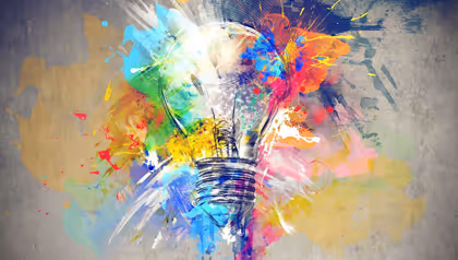 light bulb with colourful splashes of paint