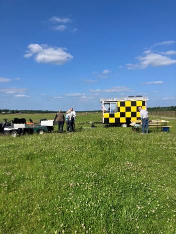 A yellow and black checkered building in a field
AI-generated content may be incorrect.